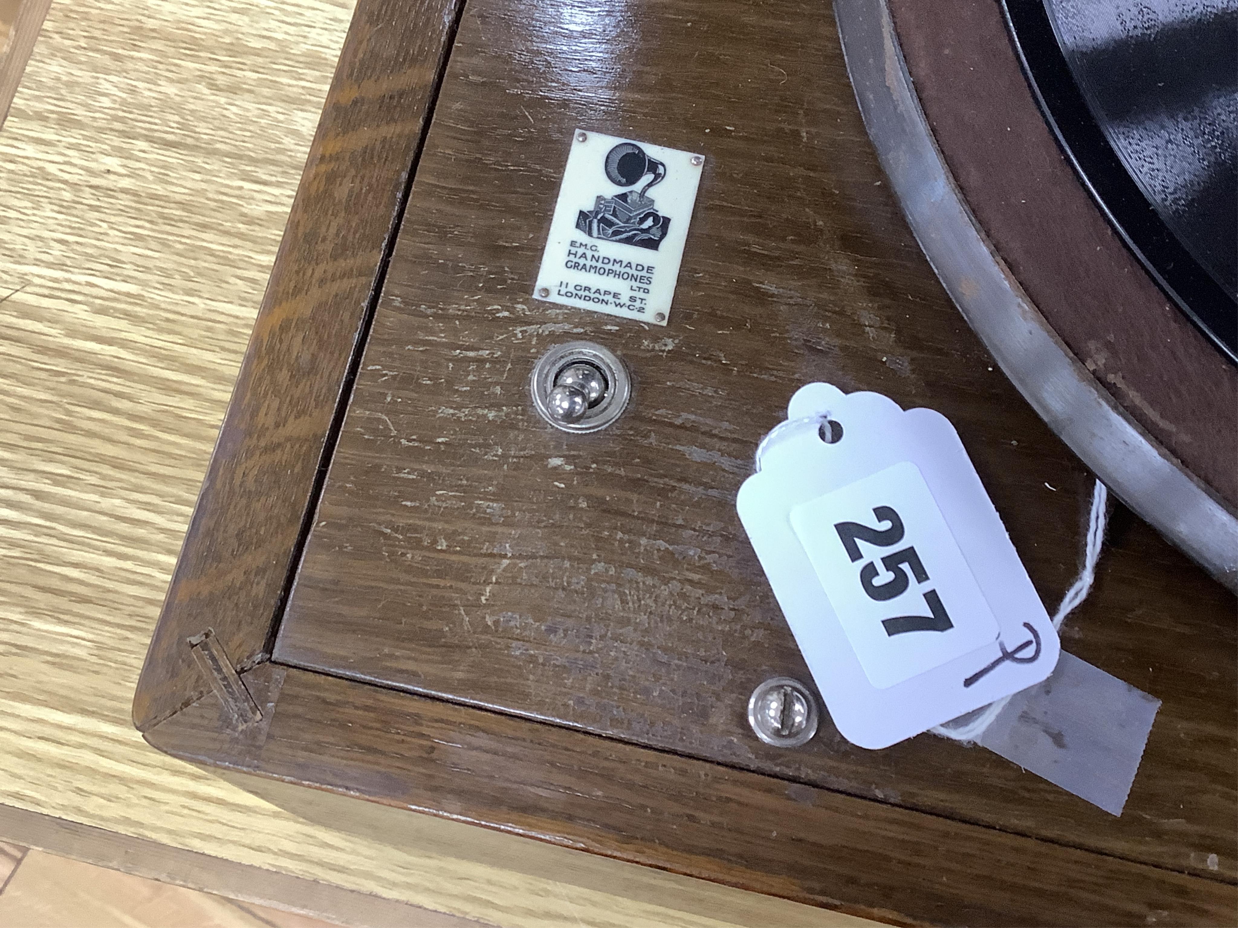An EMG ‘Handmade Gramophone’ with electrically powered motor, in an oak veneered case with large papier-mâché horn, dimensions of the case; 44 x 53 x 27cm, diameter of the horn 56cm.